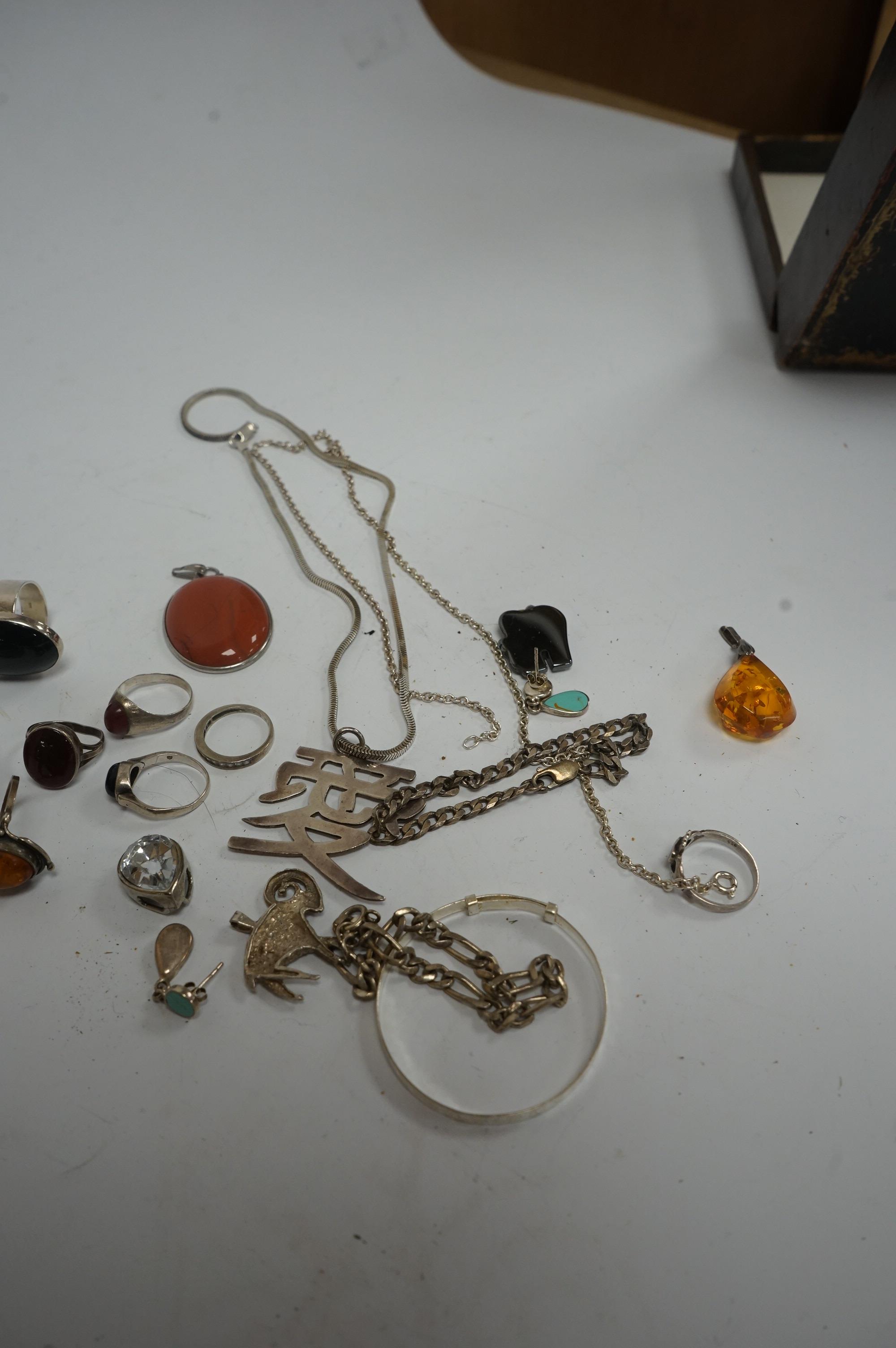 A small collection of assorted jewellery, including silver and 925 rings set with cabochon stones, a child's 925 bangle, amber jewellery, 925 necklace, etc, housed in an inlaid and cross banded box. Condition - poor to f